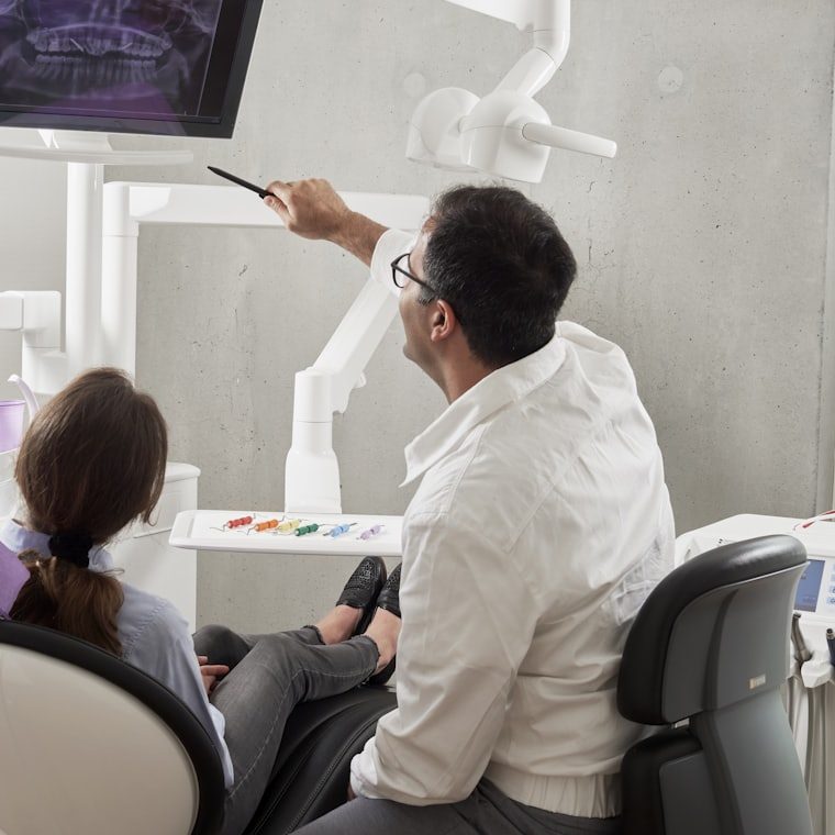 Dentist explaining a treatment to a patient